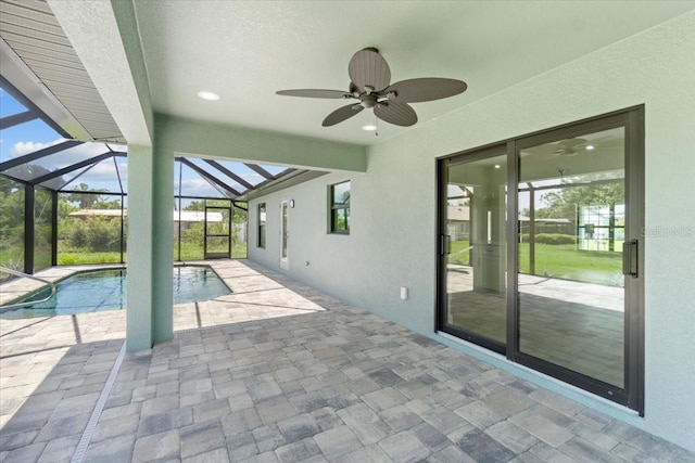 view of pool with ceiling fan, a lanai, and a patio