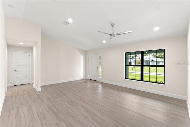 unfurnished living room featuring ceiling fan and light hardwood / wood-style floors