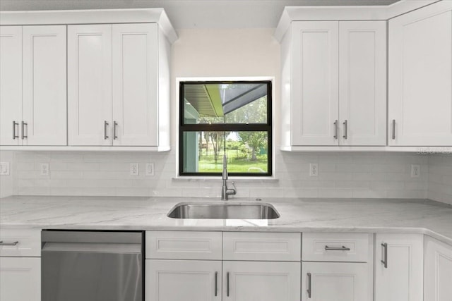 kitchen featuring sink, white cabinetry, backsplash, and dishwasher