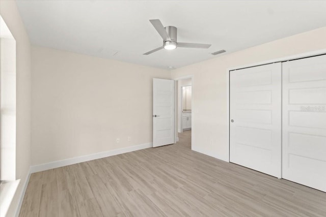 unfurnished bedroom with ceiling fan, a closet, and light hardwood / wood-style floors