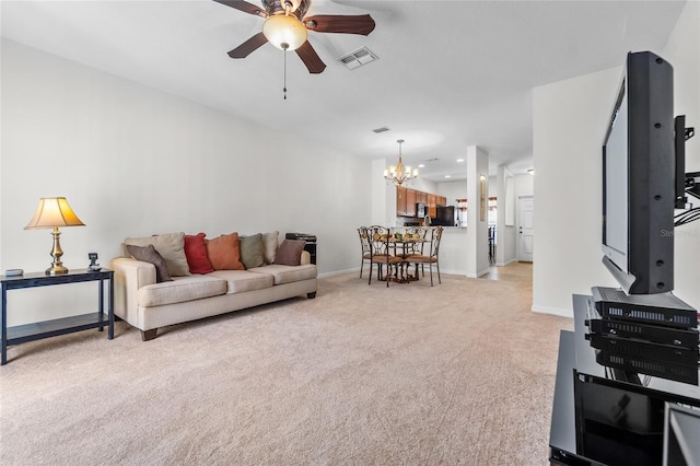 8545 Trail Wind Dr, Tampa, FL 33647 - living room featuring light carpet and ceiling fan with notable chandelier