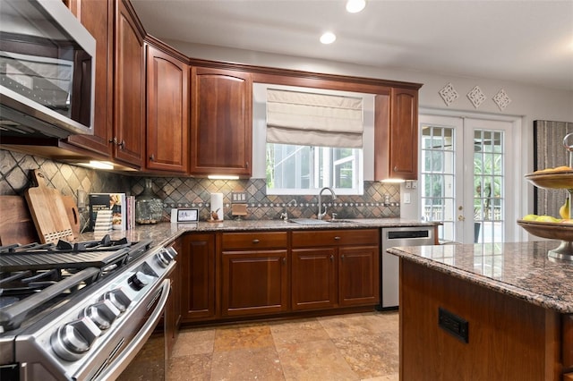 kitchen featuring appliances with stainless steel finishes, plenty of natural light, french doors, and sink