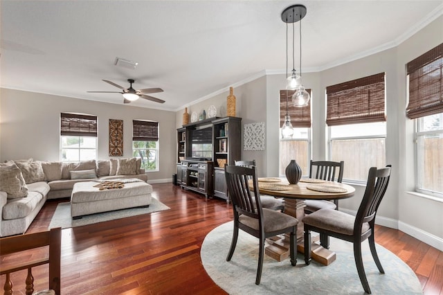 dining area featuring crown molding, ceiling fan, and dark wood-type flooring