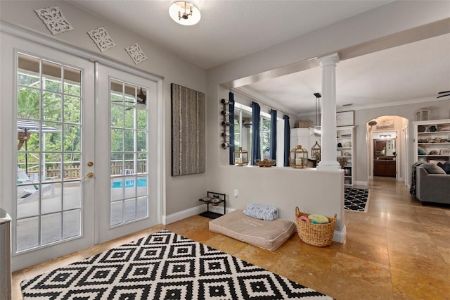 doorway to outside with french doors, ornate columns, and crown molding