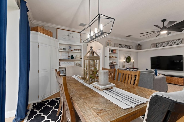 dining area with ceiling fan with notable chandelier and ornamental molding