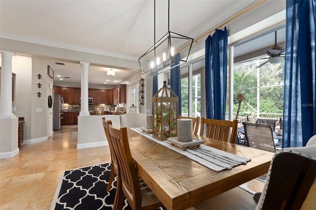 dining area featuring ceiling fan with notable chandelier and crown molding