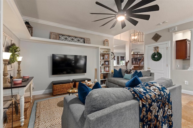 living room with a textured ceiling, ceiling fan with notable chandelier, and crown molding