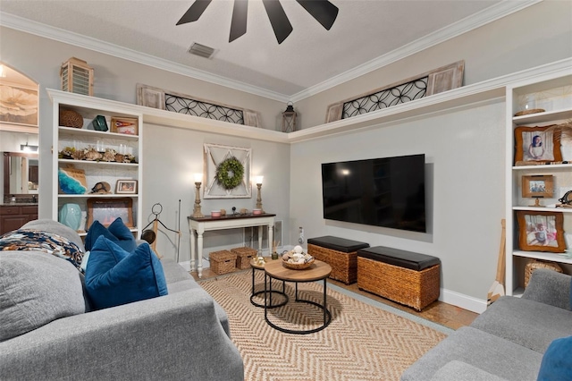 tiled living room featuring ceiling fan and crown molding