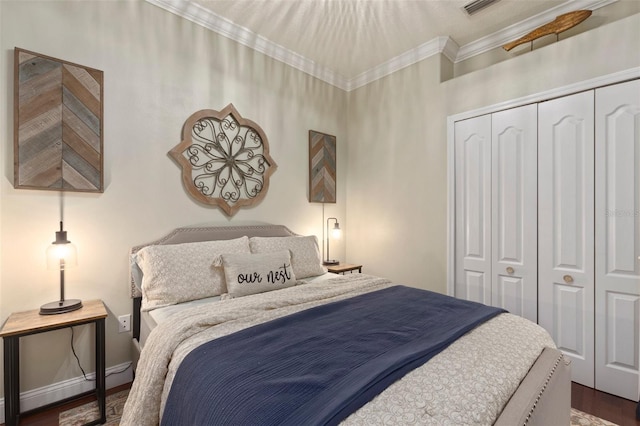 bedroom featuring dark hardwood / wood-style floors, ornamental molding, and a closet