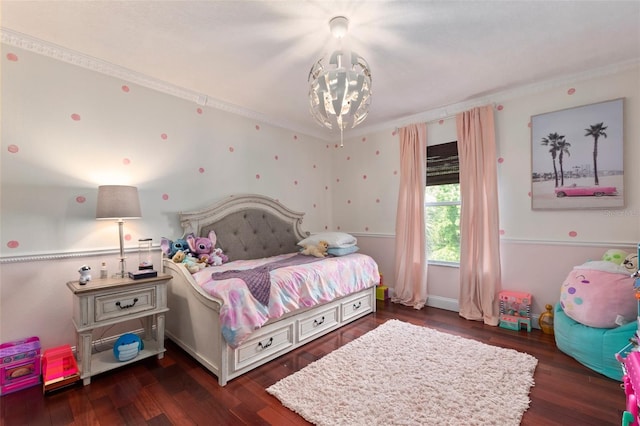 bedroom with a chandelier and dark hardwood / wood-style flooring