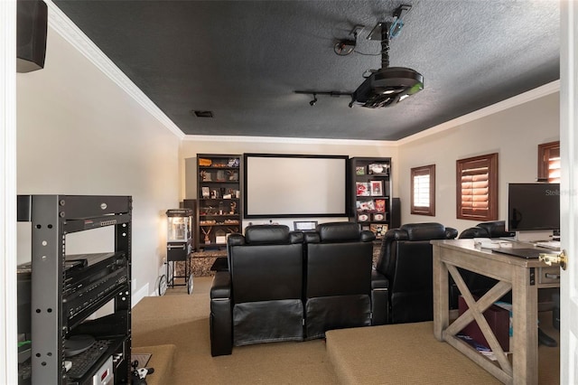 carpeted home theater room with a textured ceiling, track lighting, and crown molding