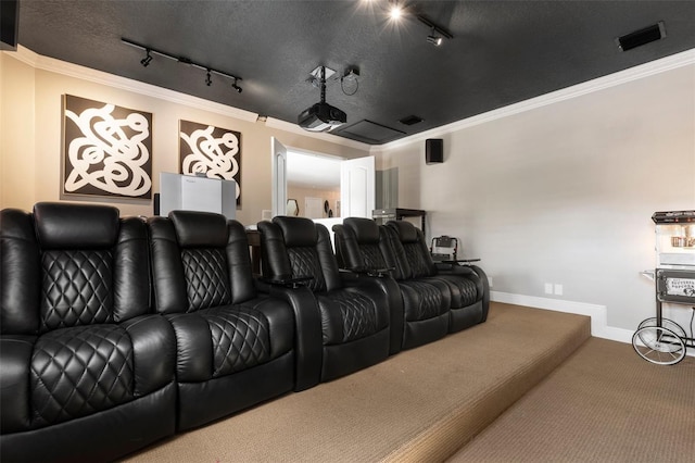 cinema room with a textured ceiling, track lighting, and crown molding