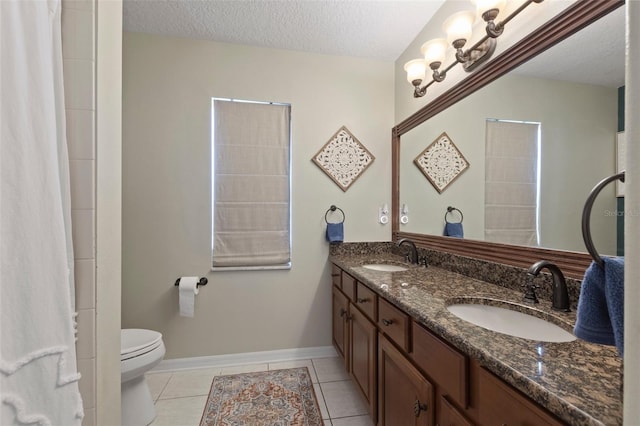 bathroom with toilet, a textured ceiling, and tile patterned floors