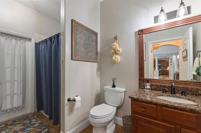 bathroom with vanity, a shower with curtain, a textured ceiling, and toilet