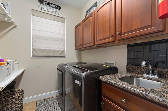 laundry room with cabinets, sink, light tile patterned floors, and washer and dryer