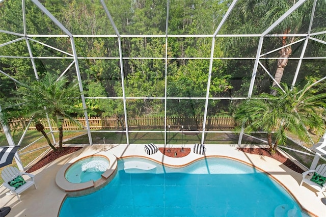 view of swimming pool with glass enclosure and an in ground hot tub