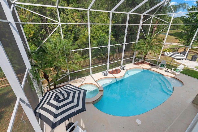 view of pool featuring a patio area, a lanai, and an in ground hot tub