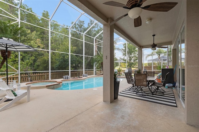 view of pool with an in ground hot tub, a patio, ceiling fan, and a lanai