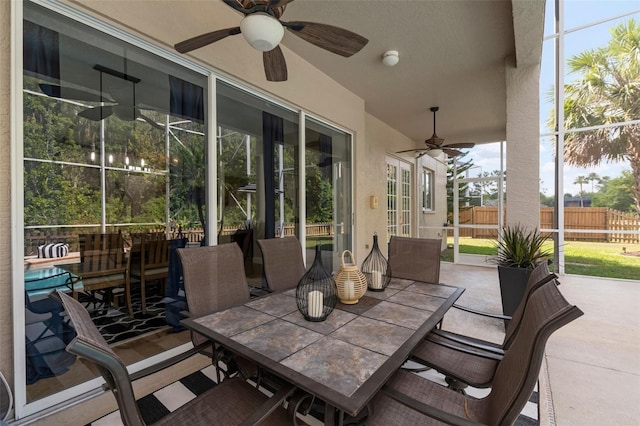 view of patio / terrace featuring ceiling fan and a lanai