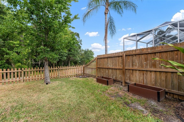 view of yard with glass enclosure