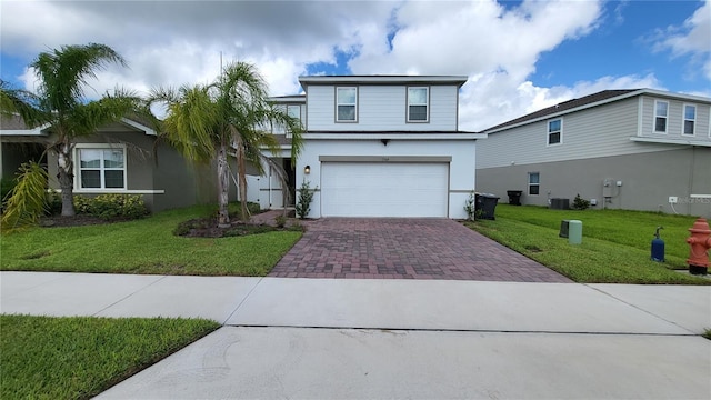 view of front facade with a front lawn, decorative driveway, an attached garage, and stucco siding