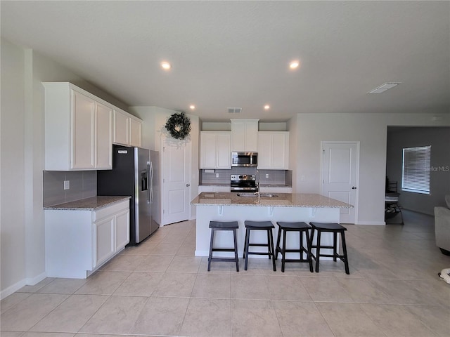 kitchen featuring white cabinets, visible vents, and stainless steel appliances