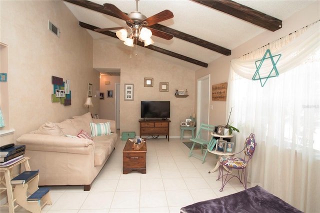 living area with ceiling fan, visible vents, vaulted ceiling with beams, and light tile patterned floors