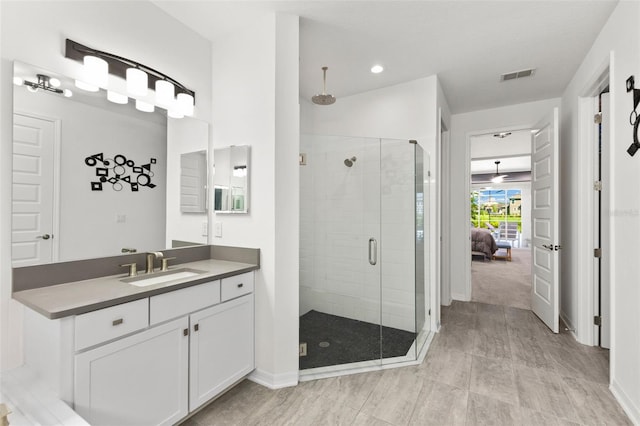 bathroom with an enclosed shower and vanity