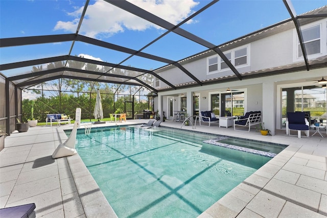 view of swimming pool with an outdoor hangout area, ceiling fan, glass enclosure, and a patio