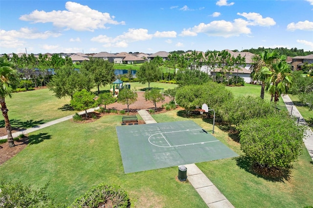 view of basketball court featuring a lawn and a playground