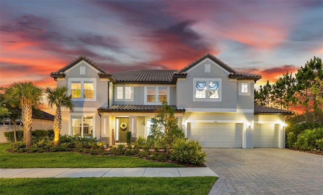 view of front of home featuring a garage and a yard