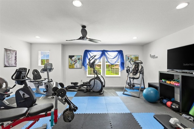 workout area with ceiling fan and a textured ceiling