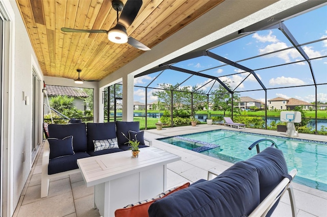 view of swimming pool featuring a patio area, a lanai, a water view, and an outdoor hangout area