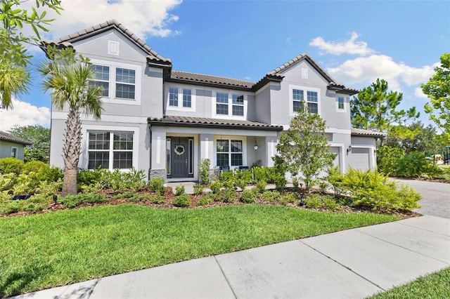 7135 Graybrook Dr, Wesley Chapel, FL 33545 - mediterranean / spanish-style home with driveway, stucco siding, a tiled roof, and a front lawn