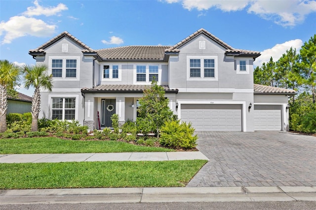 7135 Graybrook Dr, Wesley Chapel, FL 33545 - mediterranean / spanish-style home with a garage, stucco siding, decorative driveway, and a tile roof