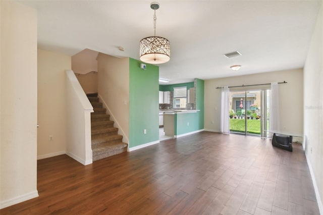 unfurnished living room with dark wood-type flooring