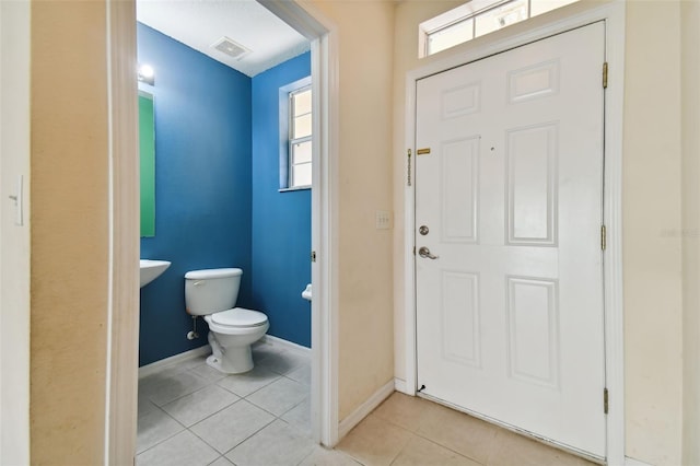 tiled foyer entrance featuring a wealth of natural light