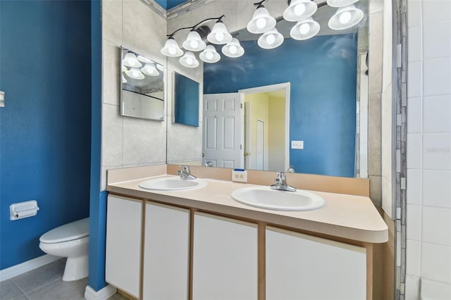 bathroom featuring tile flooring, toilet, and double sink vanity