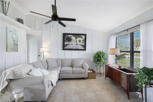 living room with vaulted ceiling, ceiling fan, and light tile floors