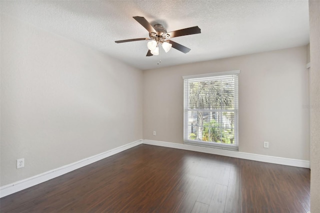 spare room featuring ceiling fan, dark hardwood / wood-style floors, and a textured ceiling