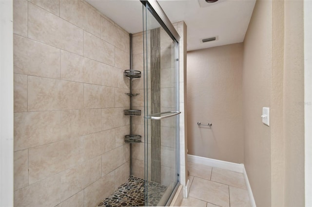 bathroom with tile patterned floors and a shower with shower door