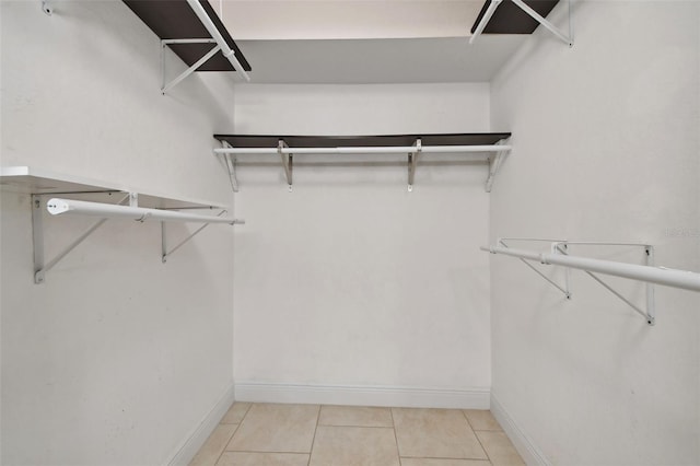 spacious closet featuring light tile patterned flooring