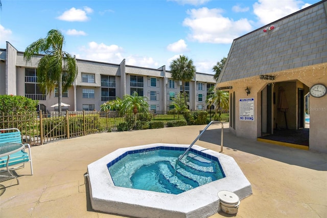 view of pool featuring a community hot tub and a patio