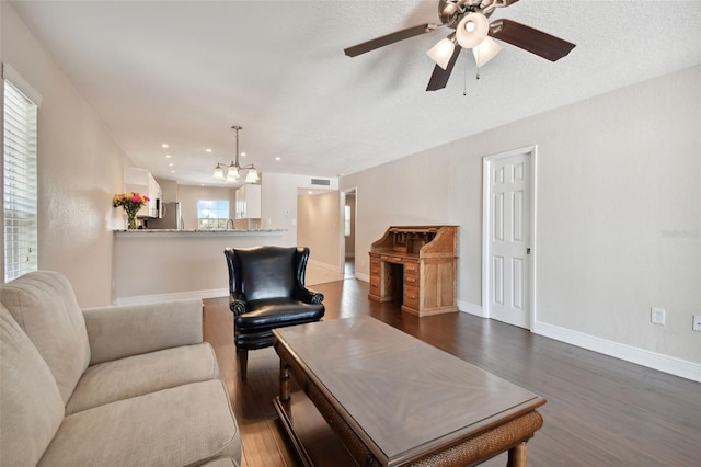 living room featuring dark hardwood / wood-style flooring and ceiling fan