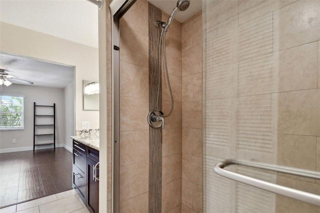 bathroom with vanity, ceiling fan, and a shower with shower door