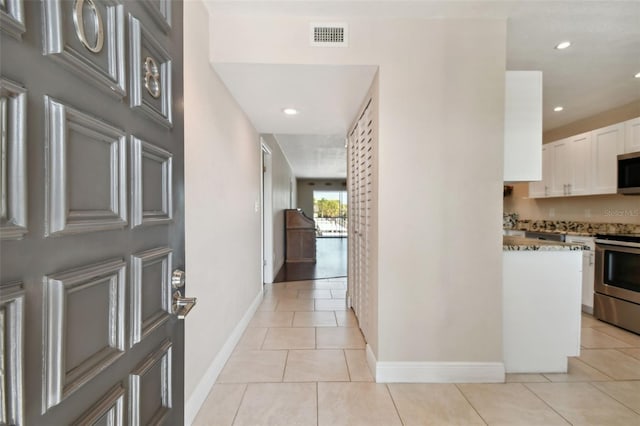 hallway with light tile patterned floors