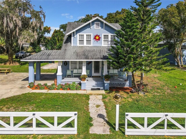 view of front facade featuring a front yard and covered porch