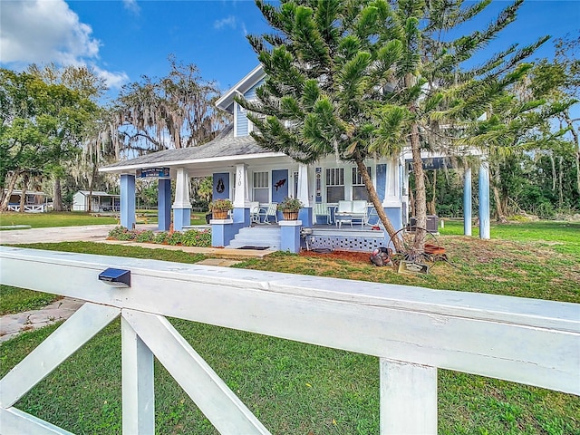 view of front facade with covered porch and a front lawn