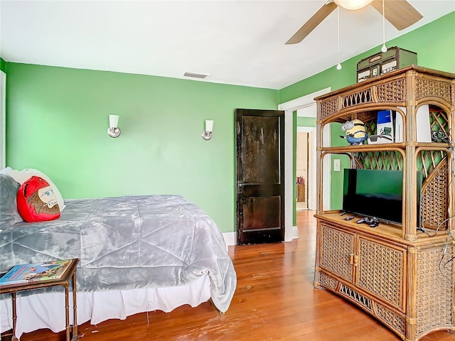 bedroom with hardwood / wood-style floors and ceiling fan