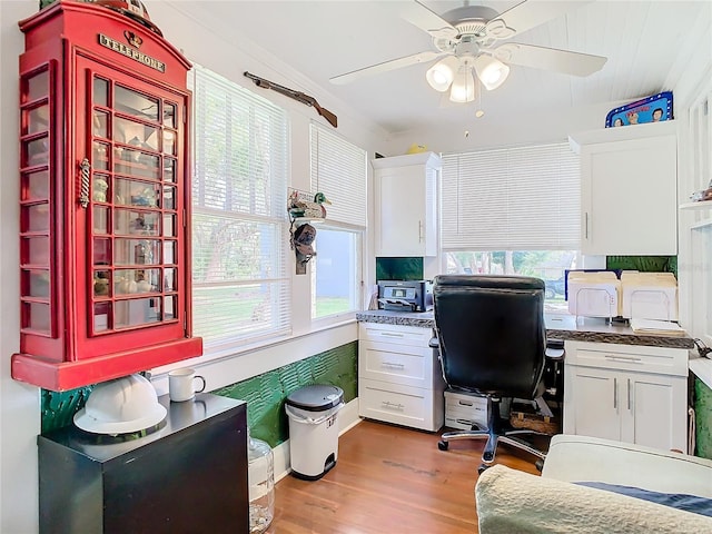 home office featuring hardwood / wood-style floors, ceiling fan, and crown molding